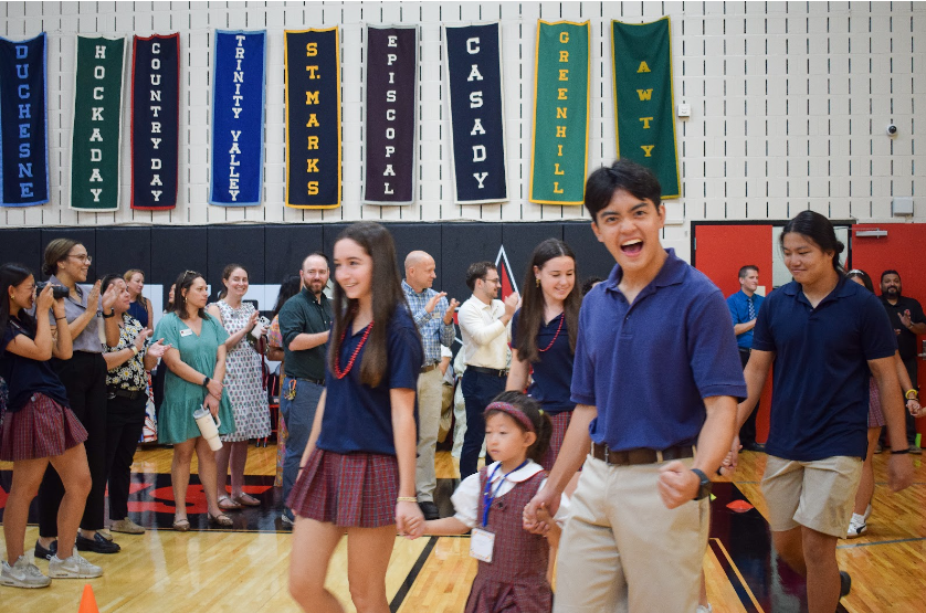 With kindergartner in hand, Head Prefect Mark Doan and senior Sammie Anaipakos get hype for the first day of school.