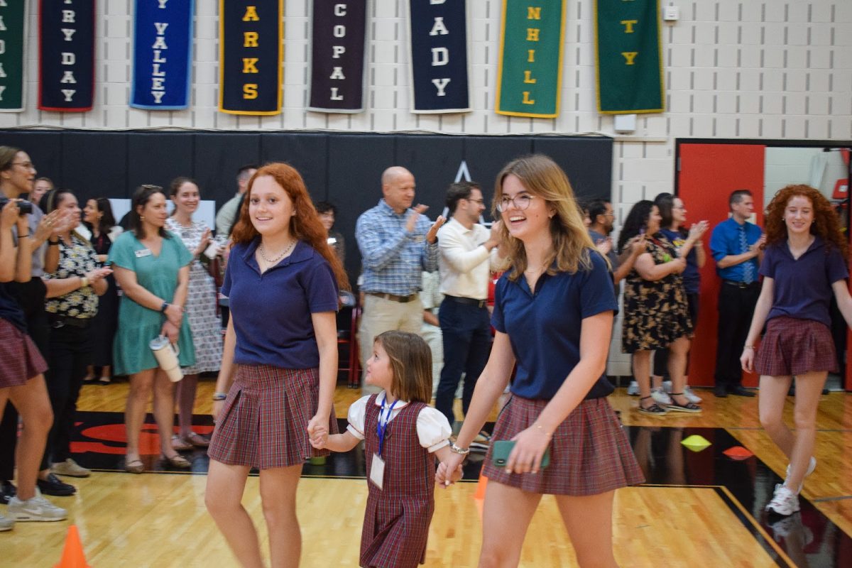 Seniors Skylar Gross and Ryan Paschke celebrate their last first day with kindergartner Sophie Almaraz’s first first day. 