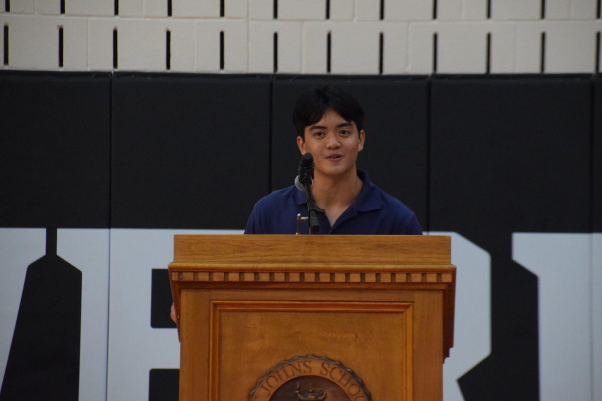 Head Prefect Mark Doan ushers in a warm welcome to the student body in Liu Court.