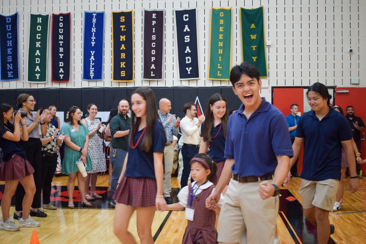 With kindergartner Astor Leung in hand, Head Prefect Mark Doan and senior Sammie Anaipakos get hype for the first day of school.
