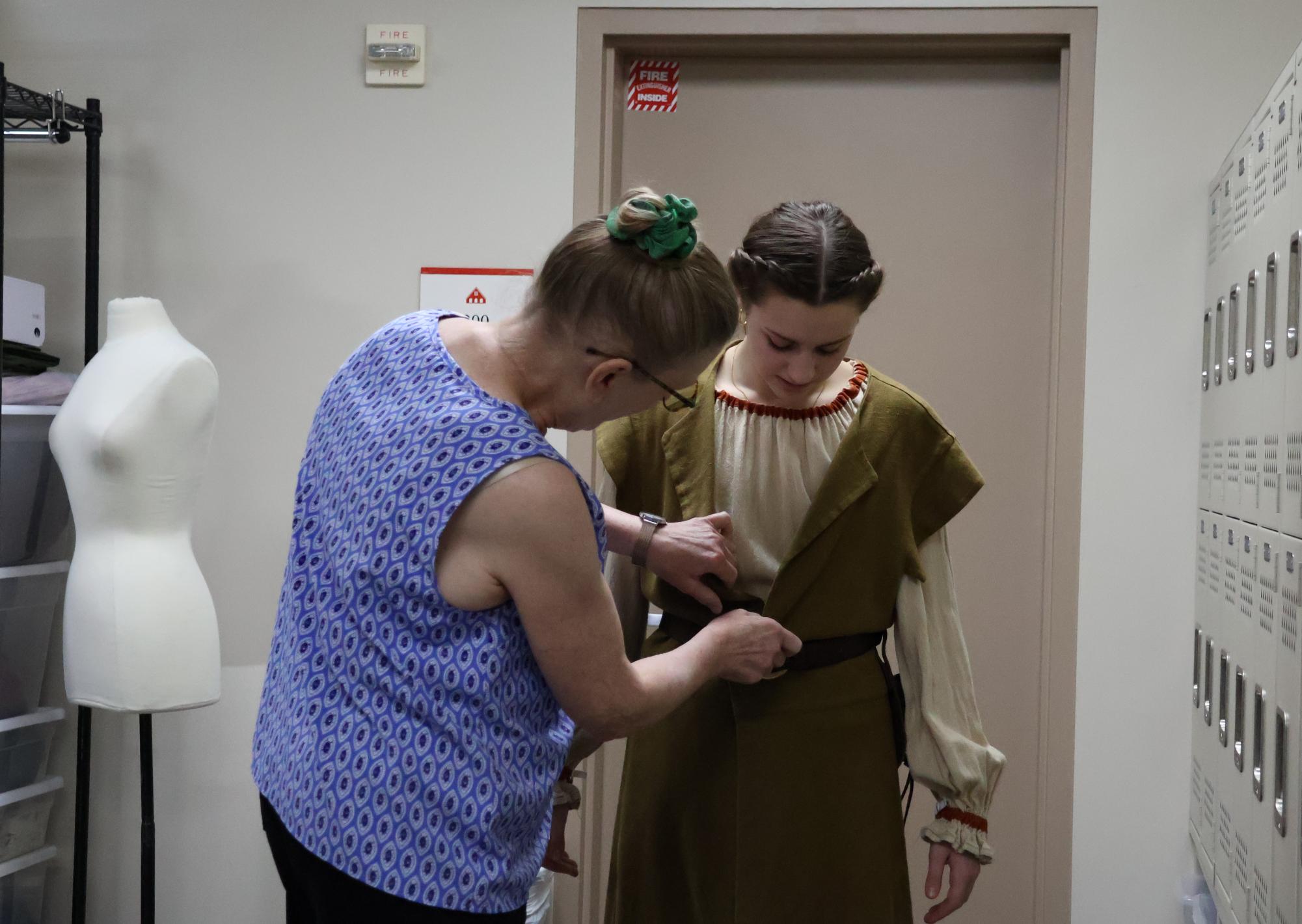 Sophomore Annie Voorhees gets fitted up by Fogler for her performance.