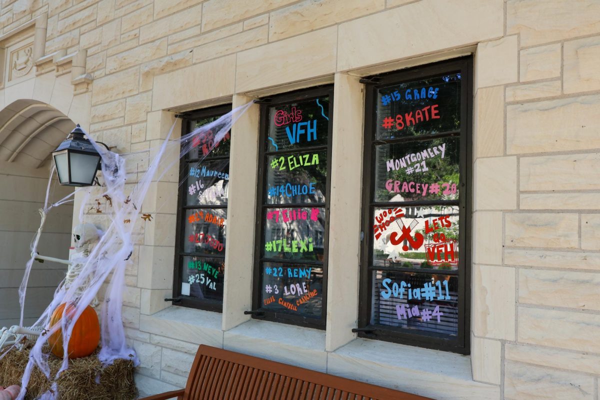 Students use glass markers to represent the Fall athletes. 