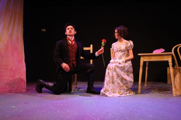 Sophomore Julian Tan (Oliver Honeytongue) romanticizes marriage with a sole rose and poetic verse, failing to charm freshman Amelia Paine (Audrey Moonover). 